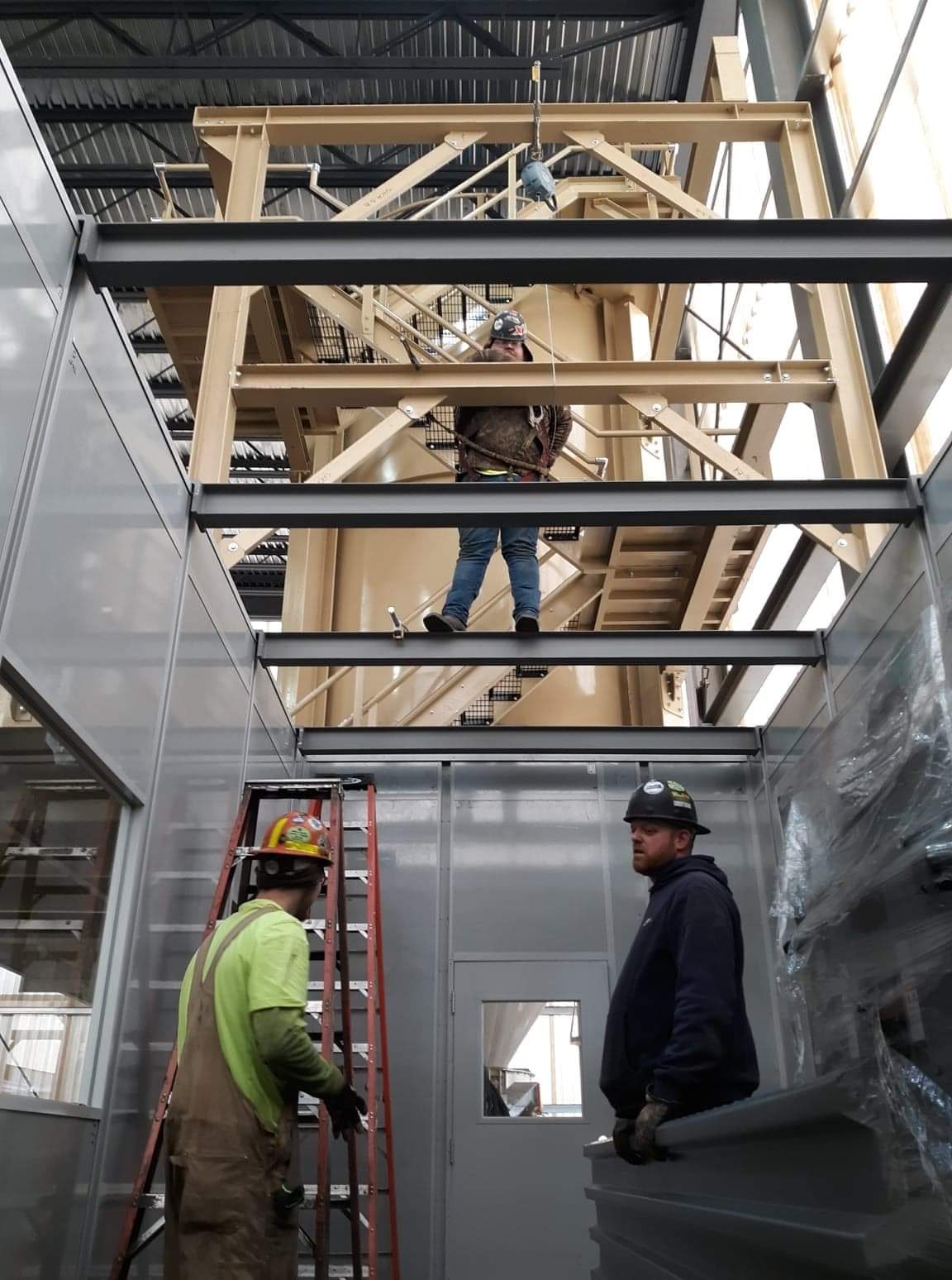 Cork ironworkers setting structural steel above a modular industrial control room